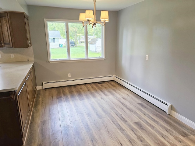 3045 W Birch Dr, Bay City, MI 48706 - unfurnished dining area featuring a chandelier, a baseboard radiator, wood finished floors, and baseboards
