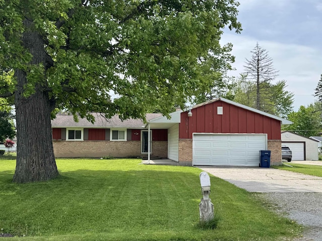 5431 Threasa St, Saginaw, MI 48603 - ranch-style house with brick siding, an attached garage, a front lawn, board and batten siding, and driveway
