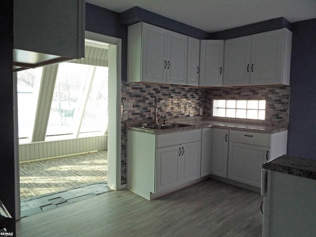 21102 Lancaster St, Harper Woods, MI 48225 - kitchen with a sink, tasteful backsplash, and white cabinetry