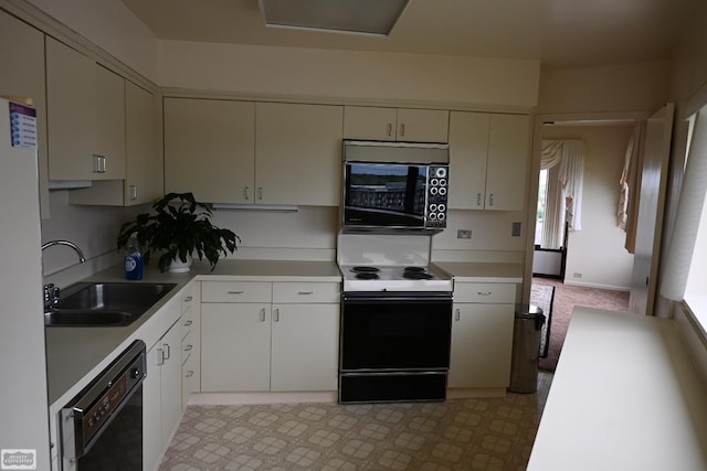5000 Town Ctr Unit 801, Southfield, MI 48075 - kitchen featuring black appliances, a sink, light countertops, and light floors