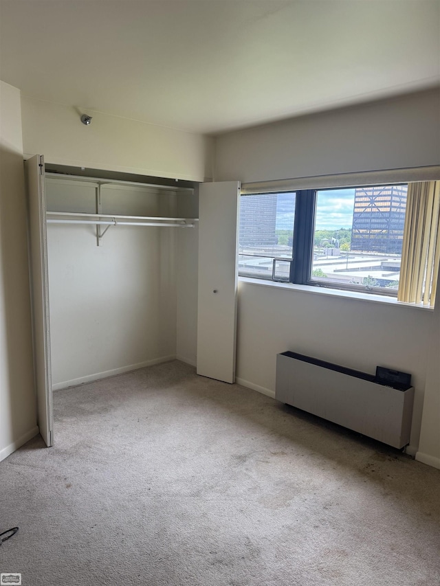 5000 Town Ctr Unit 801, Southfield, MI 48075 - unfurnished bedroom featuring carpet flooring, baseboards, a closet, and radiator