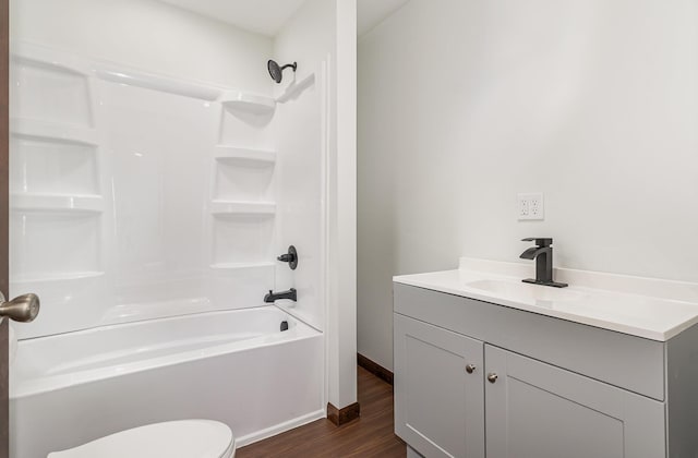 2695 Hupter Rd, Pinconning, MI 48650 - bathroom with wood finished floors, vanity, toilet, and bathtub / shower combination