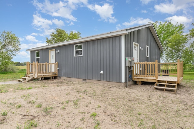 2695 Hupter Rd, Pinconning, MI 48650 - back of property with a wooden deck and crawl space