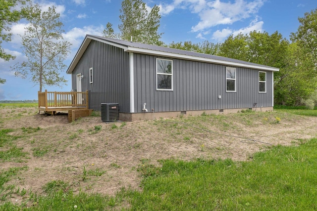 2695 Hupter Rd, Pinconning, MI 48650 - view of property exterior with a wooden deck, central AC unit, crawl space, metal roof, and board and batten siding