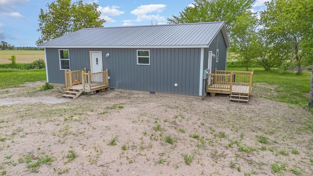 2695 Hupter Rd, Pinconning, MI 48650 - view of front of home featuring a deck and metal roof