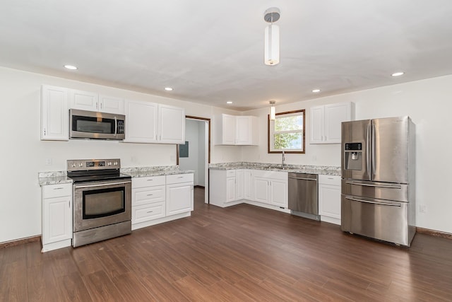2695 Hupter Rd, Pinconning, MI 48650 - kitchen with appliances with stainless steel finishes, dark wood-style flooring, white cabinets, recessed lighting, and light stone countertops