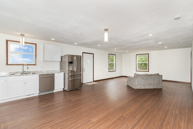 2695 Hupter Rd, Pinconning, MI 48650 - kitchen with stainless steel appliances, a sink, white cabinetry, open floor plan, and recessed lighting