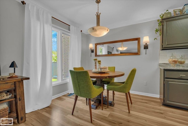 4916 Royal Cove Dr, Shelby Twp, MI 48316 - dining area with light wood-style floors, baseboards, healthy amount of natural light, and crown molding