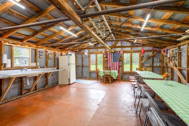 4449 S M 18 Hwy, Beaverton, MI 48612 - miscellaneous room with vaulted ceiling, plenty of natural light, and concrete floors