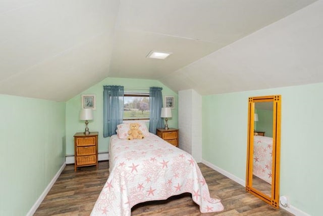 4449 S M 18 Hwy, Beaverton, MI 48612 - bedroom featuring wood finished floors, baseboards, vaulted ceiling, and baseboard heating