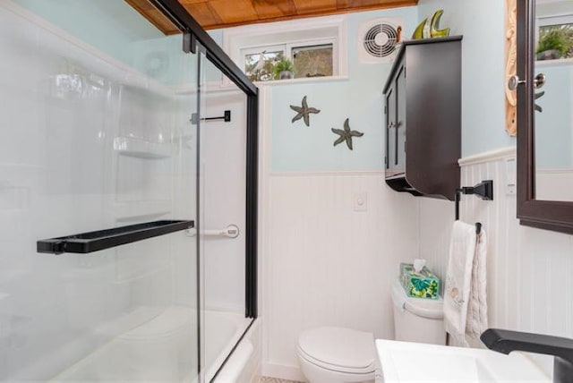 4449 S M 18 Hwy, Beaverton, MI 48612 - bathroom featuring a sink, toilet, wainscoting, and combined bath / shower with glass door