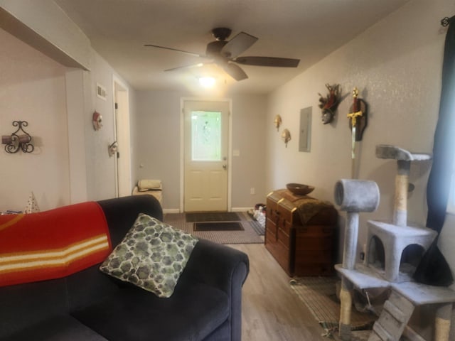 6130 Beech Dr, Lake, MI 48632 - living room featuring ceiling fan, wood finished floors, and electric panel