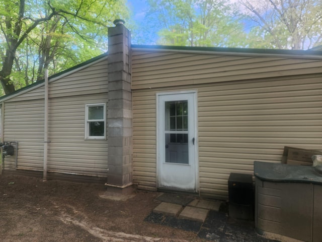 6130 Beech Dr, Lake, MI 48632 - back of house featuring a chimney