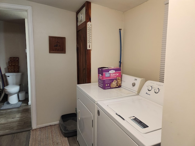 6130 Beech Dr, Lake, MI 48632 - washroom with independent washer and dryer, wood finished floors, and baseboards