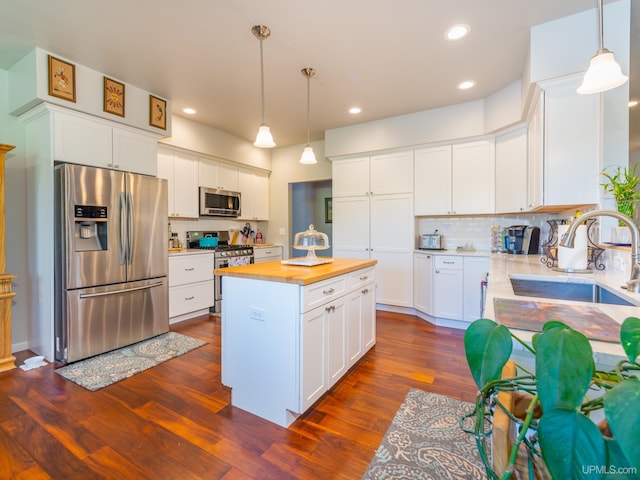 217 Shoreline Dr, Negaunee, MI 49866 - kitchen featuring stainless steel appliances, a sink, butcher block counters, tasteful backsplash, and dark wood-style flooring