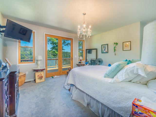 217 Shoreline Dr, Negaunee, MI 49866 - carpeted bedroom featuring access to exterior and a chandelier