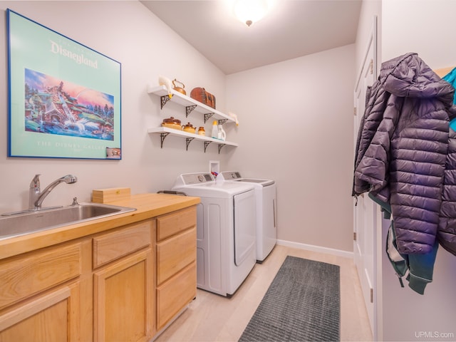 217 Shoreline Dr, Negaunee, MI 49866 - laundry room featuring independent washer and dryer, cabinet space, and light tile patterned floors