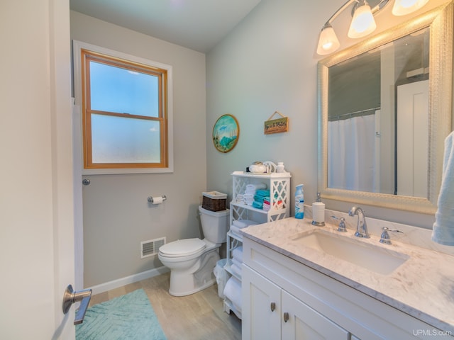 217 Shoreline Dr, Negaunee, MI 49866 - full bathroom with vanity, toilet, and baseboards