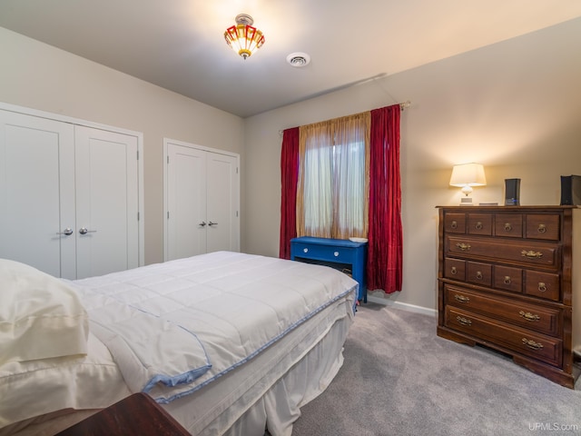 217 Shoreline Dr, Negaunee, MI 49866 - bedroom featuring carpet, baseboards, and two closets