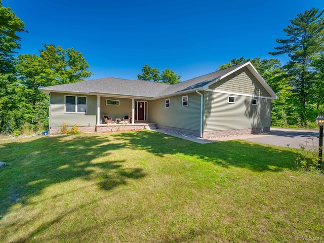 217 Shoreline Dr, Negaunee, MI 49866 - ranch-style house featuring covered porch and a front lawn