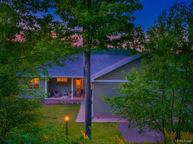 217 Shoreline Dr, Negaunee, MI 49866 - rear view of property with a yard, a shingled roof, and a patio area