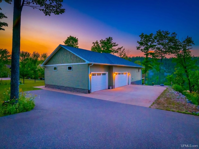217 Shoreline Dr, Negaunee, MI 49866 - view of garage at dusk