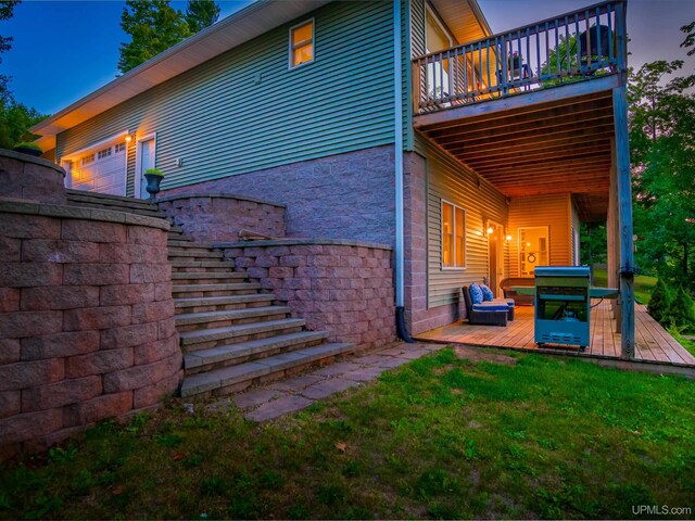 217 Shoreline Dr, Negaunee, MI 49866 - rear view of house featuring a deck, a lawn, and stone siding