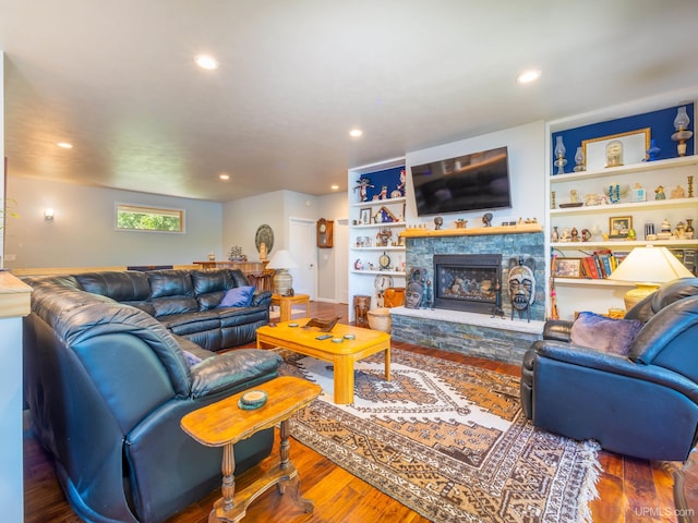 217 Shoreline Dr, Negaunee, MI 49866 - living room featuring recessed lighting, wood finished floors, and a stone fireplace