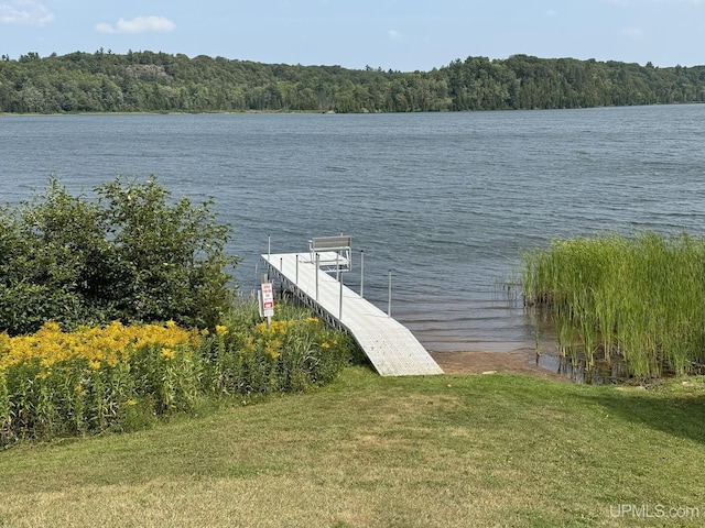 217 Shoreline Dr, Negaunee, MI 49866 - dock area featuring a water view, a lawn, and a forest view