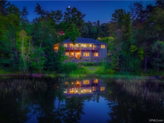 217 Shoreline Dr, Negaunee, MI 49866 - rear view of property featuring a balcony, a wooded view, and a water view