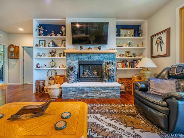 217 Shoreline Dr, Negaunee, MI 49866 - living area featuring wood finished floors, a fireplace, and built in shelves