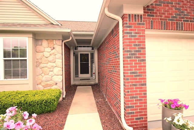 52834 Sable Dr, Macomb, MI 48042 - entrance to property featuring a garage, brick siding, and a shingled roof