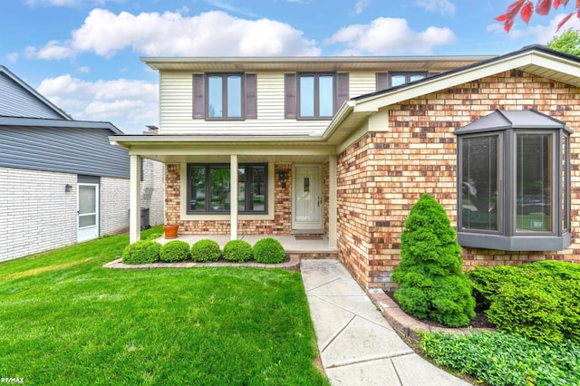 39067 Baroque Blvd, Clinton Township, MI 48038 - view of front of home featuring brick siding, a porch, and a front yard
