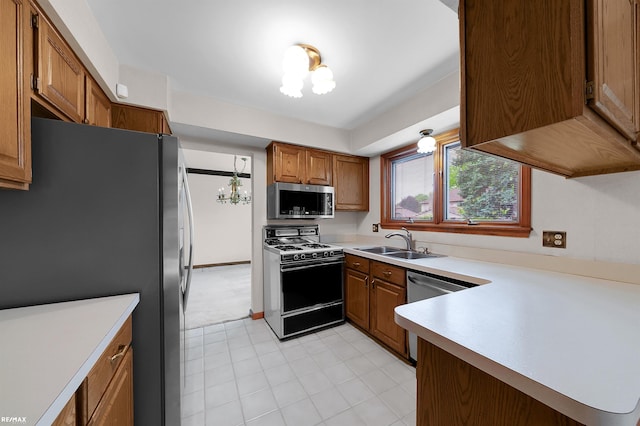 39067 Baroque Blvd, Clinton Township, MI 48038 - kitchen featuring appliances with stainless steel finishes, a sink, brown cabinets, light countertops, and a chandelier