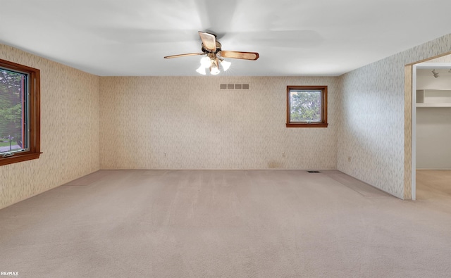 39067 Baroque Blvd, Clinton Township, MI 48038 - spare room with wallpapered walls, light carpet, and ceiling fan