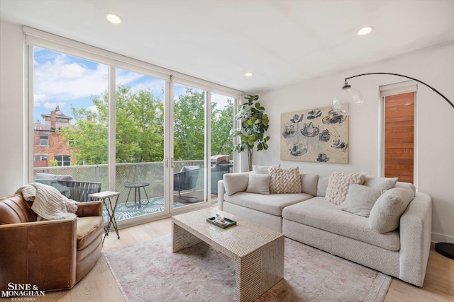 2638 John R St, Detroit, MI 48201 - living room featuring healthy amount of natural light, light wood-type flooring, recessed lighting, and a wall of windows