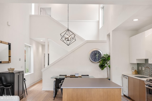 2638 John R St, Detroit, MI 48201 - kitchen with appliances with stainless steel finishes, a sink, modern cabinets, light countertops, and light wood-style flooring