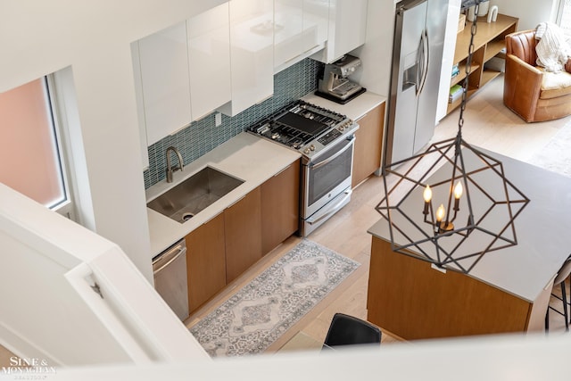 2638 John R St, Detroit, MI 48201 - kitchen with appliances with stainless steel finishes, a sink, white cabinetry, and light countertops