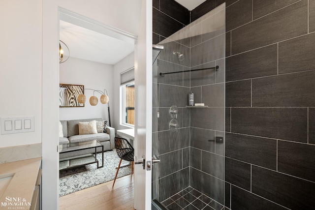 2638 John R St, Detroit, MI 48201 - bathroom featuring a tile shower, wood finished floors, and vanity