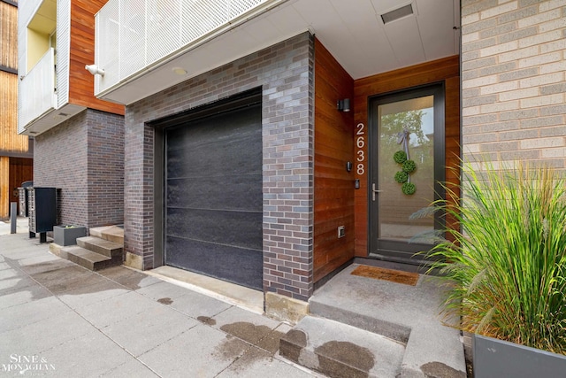2638 John R St, Detroit, MI 48201 - view of exterior entry featuring a garage and brick siding
