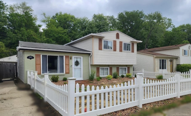 24725 Orchid St, Harrison Twp, MI 48045 - split level home with a fenced front yard and view of scattered trees