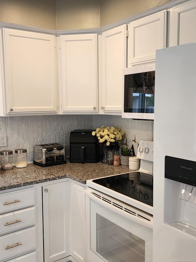 24725 Orchid St, Harrison Twp, MI 48045 - kitchen with white appliances, white cabinets, tasteful backsplash, and dark stone countertops