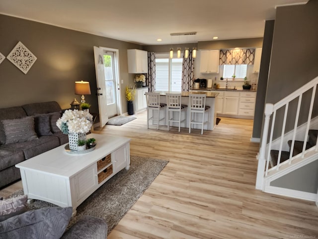 24725 Orchid St, Harrison Twp, MI 48045 - living room featuring stairway, light wood-style floors, baseboards, and recessed lighting