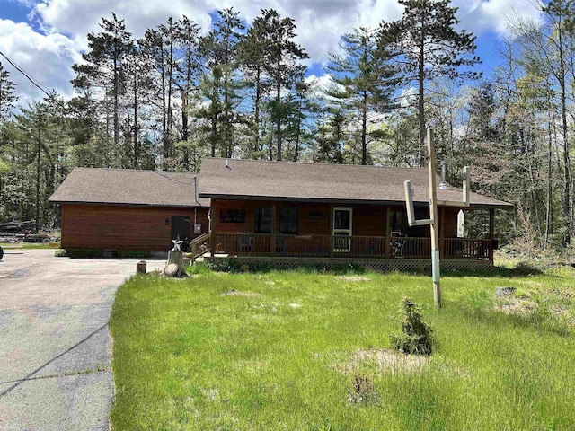 5077 Henry Hwy, Lewiston, MI 49756 - ranch-style home with covered porch, driveway, and roof with shingles