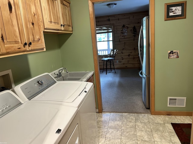 5077 Henry Hwy, Lewiston, MI 49756 - laundry room with cabinet space, independent washer and dryer, wooden walls, light carpet, and baseboards