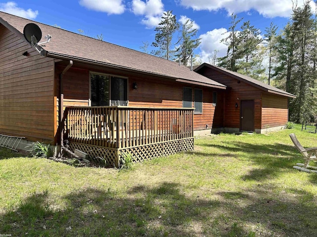 5077 Henry Hwy, Lewiston, MI 49756 - back of house featuring a deck, a yard, and roof with shingles