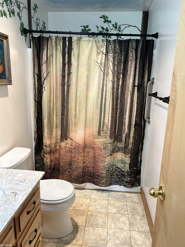 5077 Henry Hwy, Lewiston, MI 49756 - full bath featuring toilet, vanity, a shower with curtain, and stone finish floors