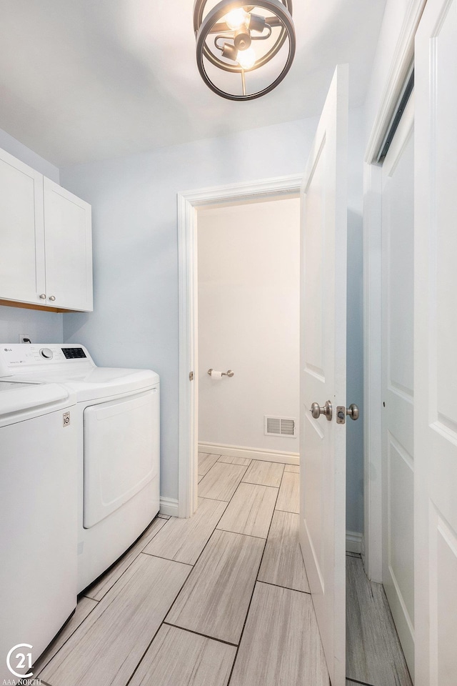 229 Mussey St, Romeo, MI 48065 - laundry room with cabinet space, washer and clothes dryer, wood finish floors, and baseboards