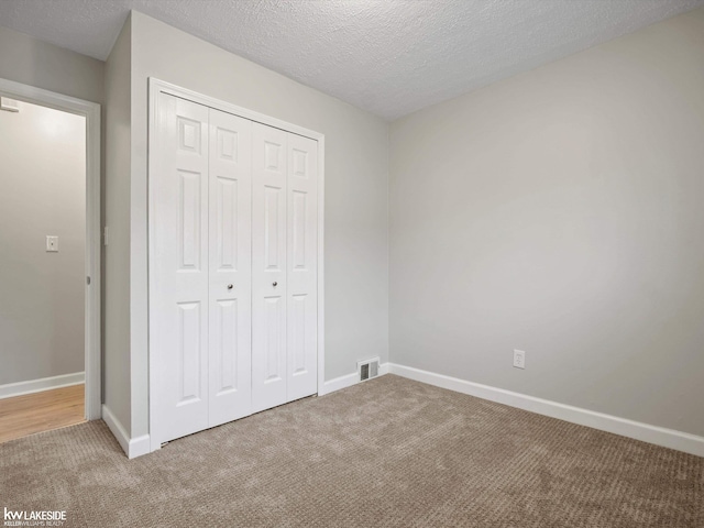 3422 S Annabelle St, Detroit, MI 48217 - unfurnished bedroom featuring carpet floors, a closet, baseboards, and a textured ceiling