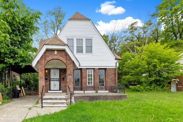 5553 Nottingham Rd, Detroit, MI 48224 - tudor house with brick siding, covered porch, and roof with shingles